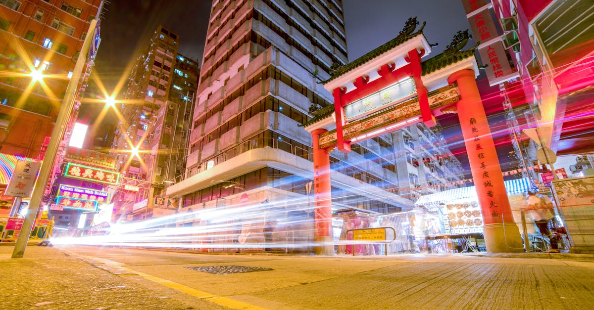 Dynamic light trails and urban architecture in Kowloon, capturing Hong Kong's vibrant nightlife.