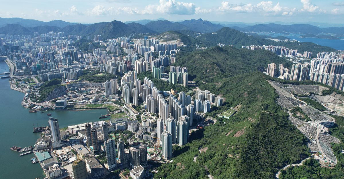 A breathtaking aerial view of Kowloon, blending urban skyline with lush green hills.