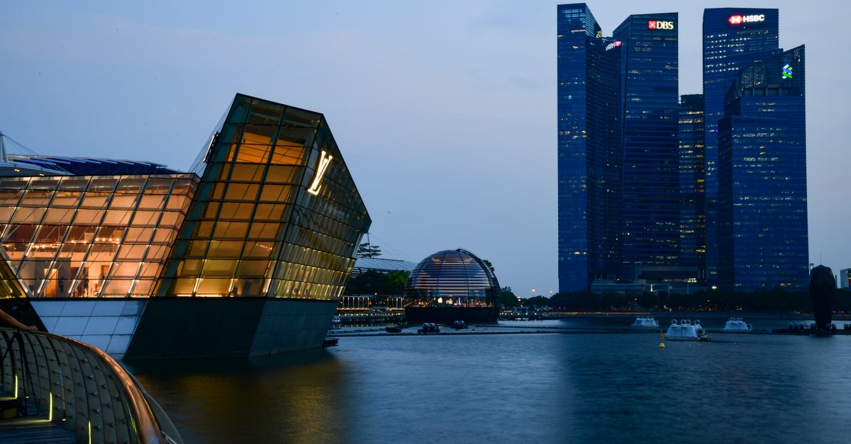 Dusk view of Marina Bay, Singapore with futuristic skyscrapers and waterfront.