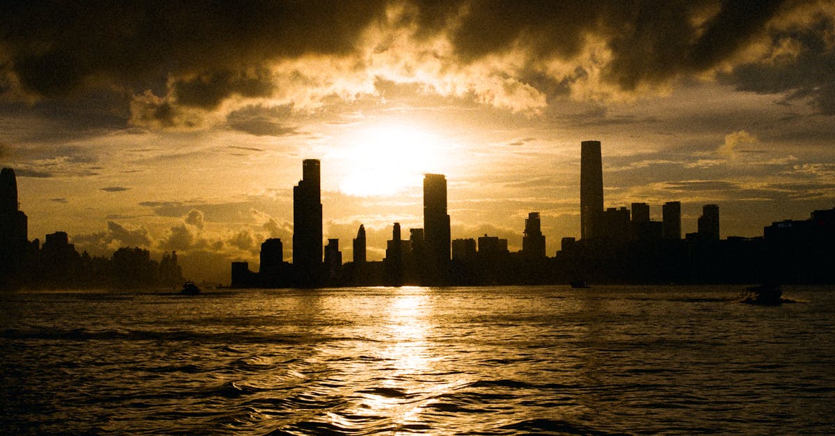 A breathtaking silhouette of Hong Kong's skyline against a vibrant sunset sky.