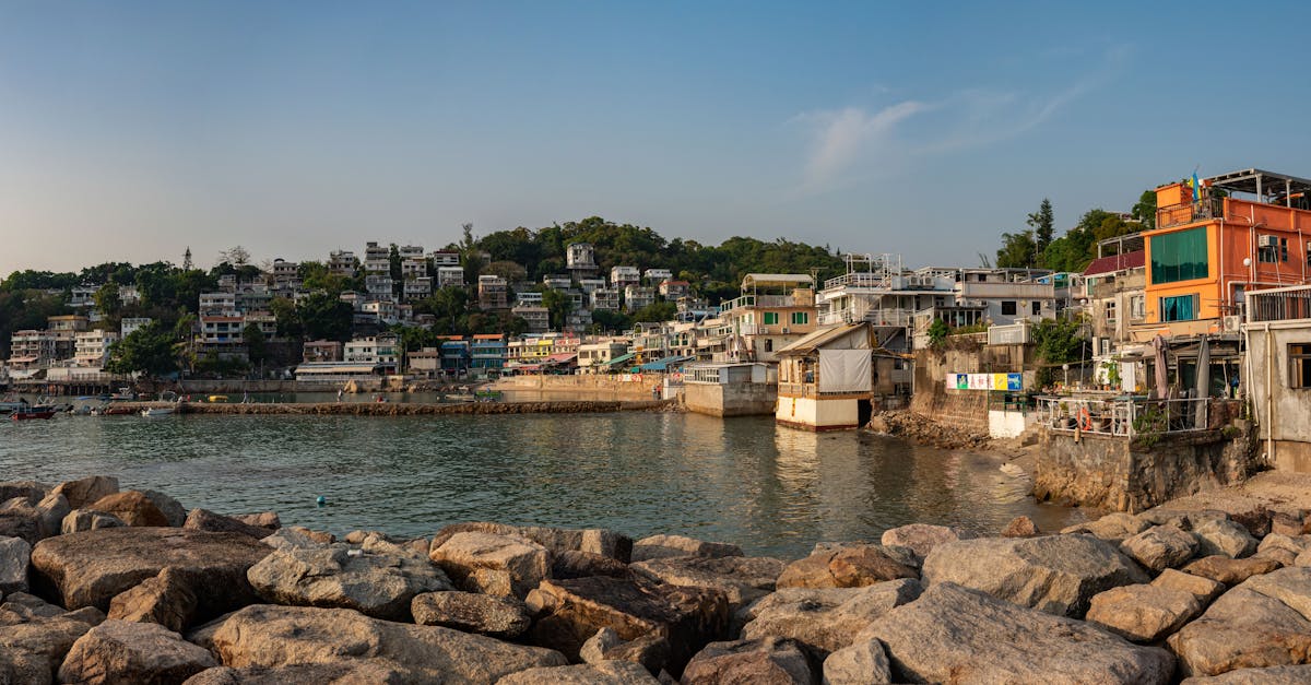 Panoramic view of a scenic Hong Kong fishing village, showcasing colorful buildings by the sea.
