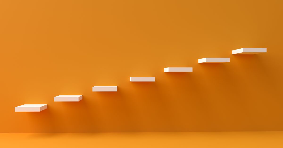White floating steps on vibrant orange wall create a minimalist and conceptual design.