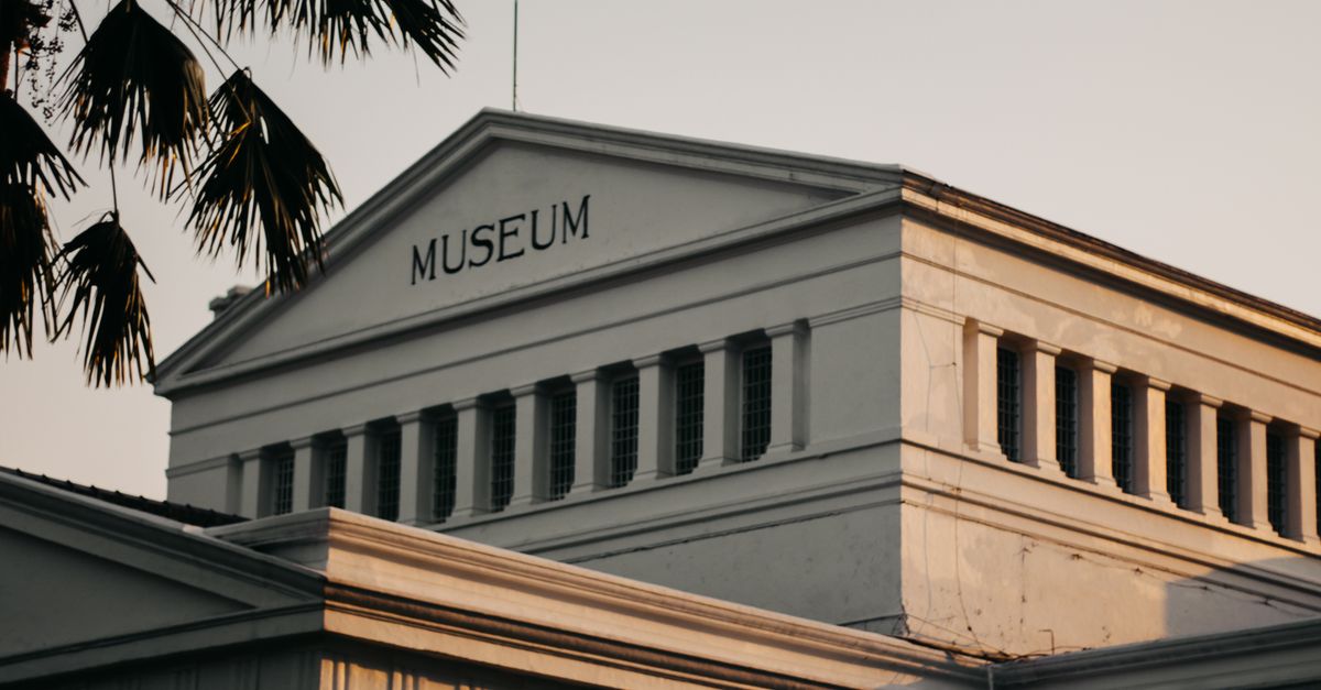 Low angle view of a historic museum building in urban setting at sunset.