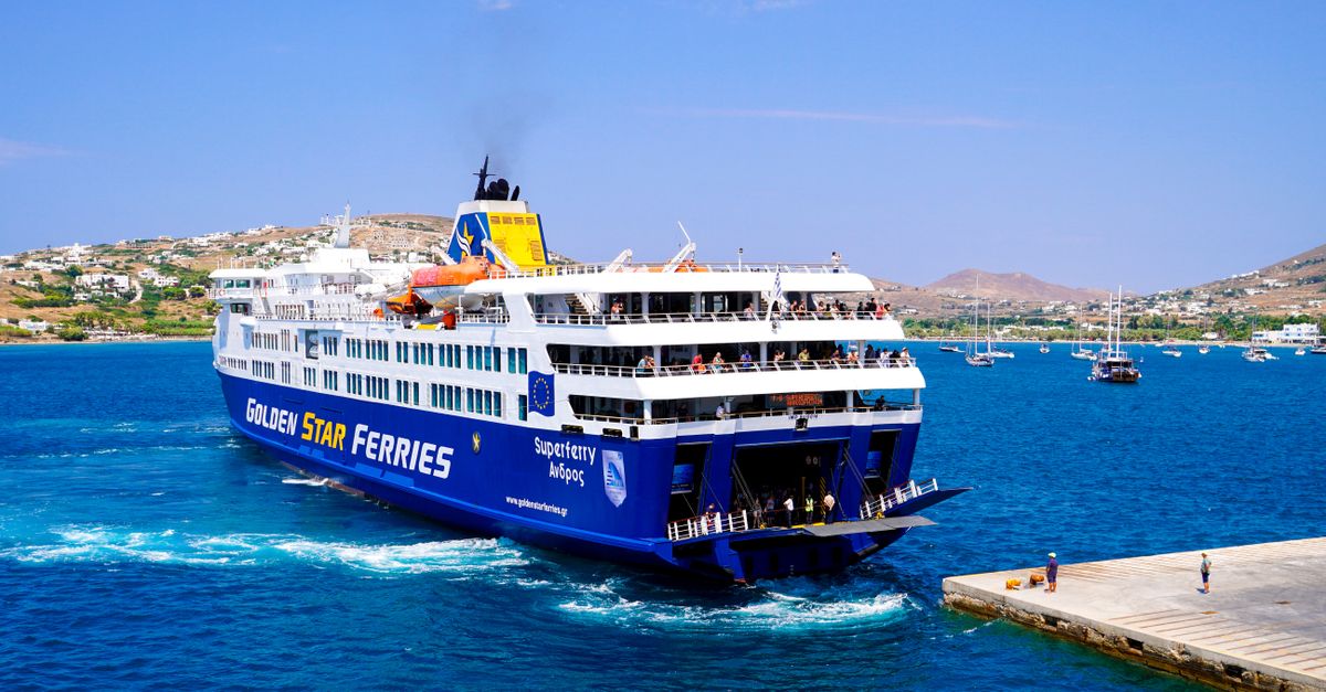 A vibrant image of a Golden Star ferry approaching a Greek island pier under a clear blue sky.