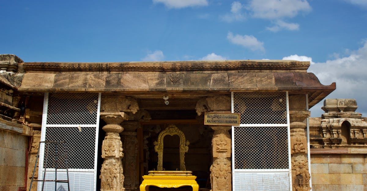 Stunning view of an ancient stone temple entrance with intricate carvings under clear blue skies.