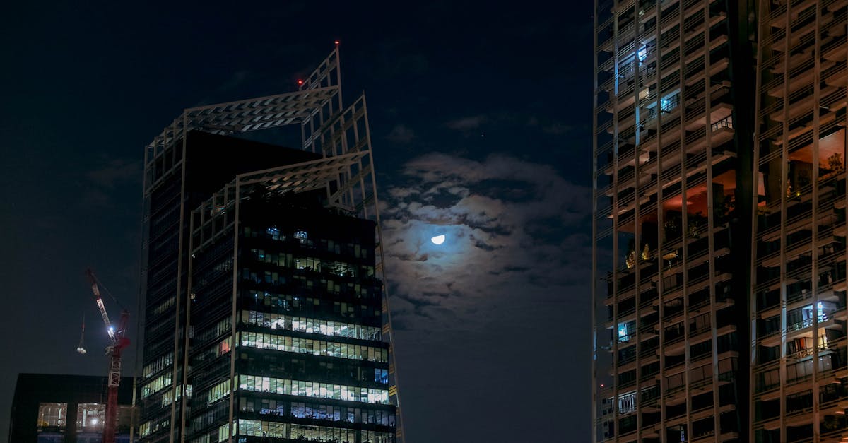 Singapore cityscape featuring modern skyscrapers and a glowing moon, capturing the vibrant nightlife.