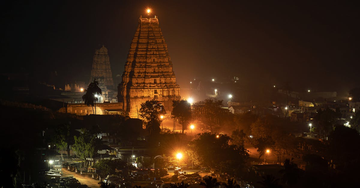 Stunning night view of the illuminated Virupaksha Temple, a UNESCO World Heritage Site in Hampi, India.