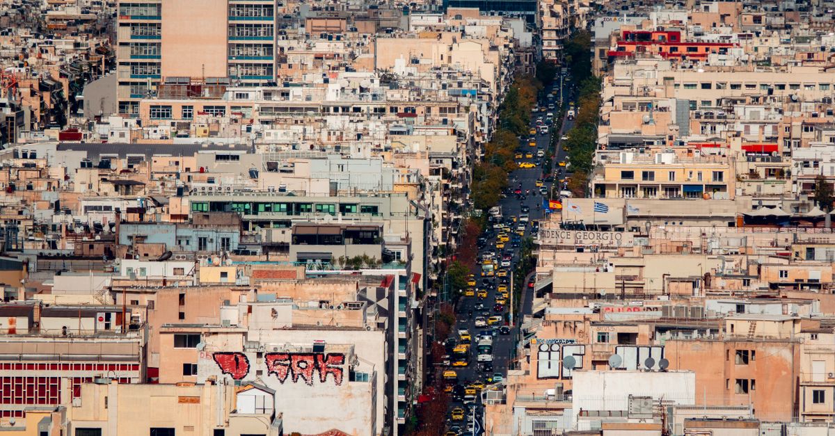 A vibrant aerial view of a bustling cityscape filled with dense buildings and busy streets.