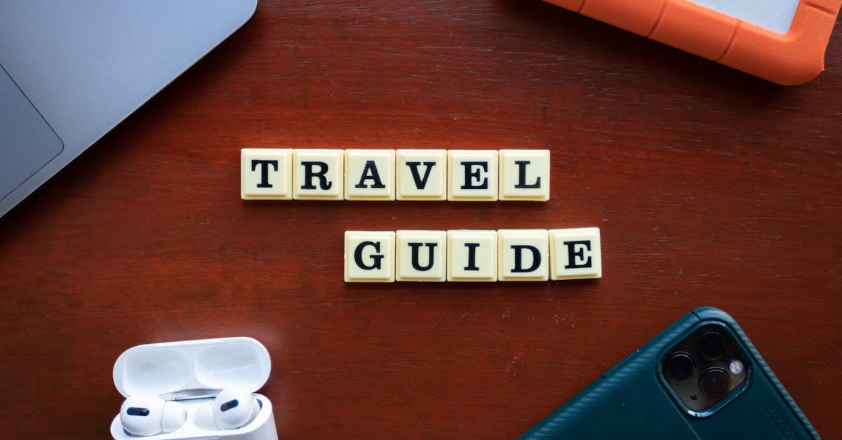 Flat lay of travel guide concept with smartphone, laptop, and headphones.