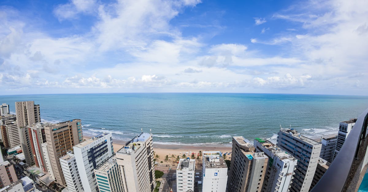 Stunning aerial view of Recife's urban coastline, showcasing modern architecture against the ocean.