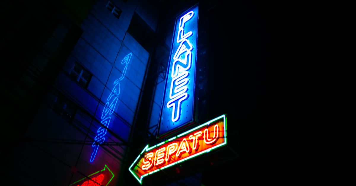 Vibrant neon signs illuminate the urban nightscape in Kota Garut, Indonesia.