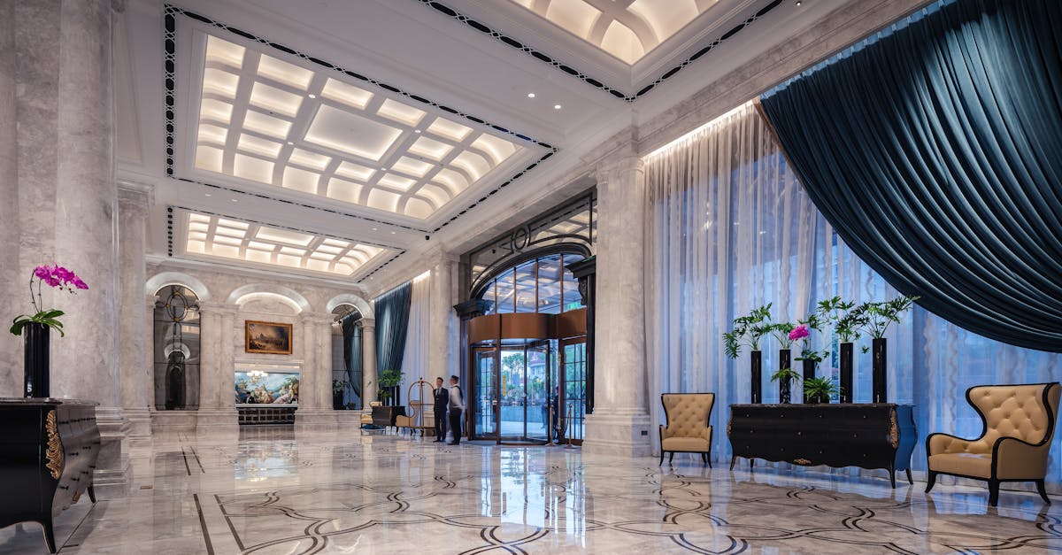 Elegant hotel lobby with high ceilings, marble floors, and opulent decor.