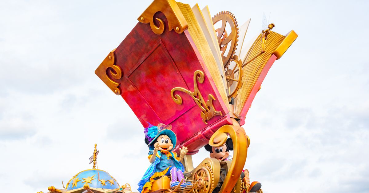Vibrant Disney parade float featuring iconic characters with a large storybook theme.