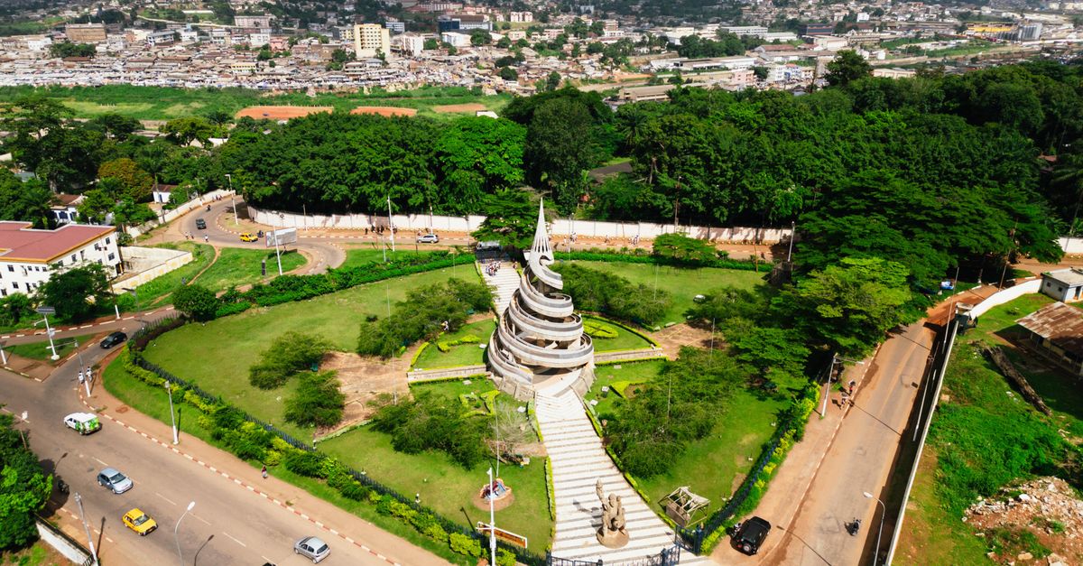 A stunning aerial shot of the Reunification Monument surrounded by greenery in Yaoundé, Cameroon.
