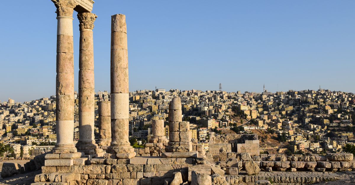 Majestic view of the Temple of Hercules ruins against Amman's sprawling cityscape.