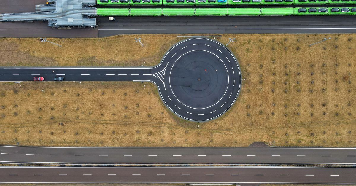 Aerial photo showcasing a modern roundabout and highway from above, highlighting road geometry.