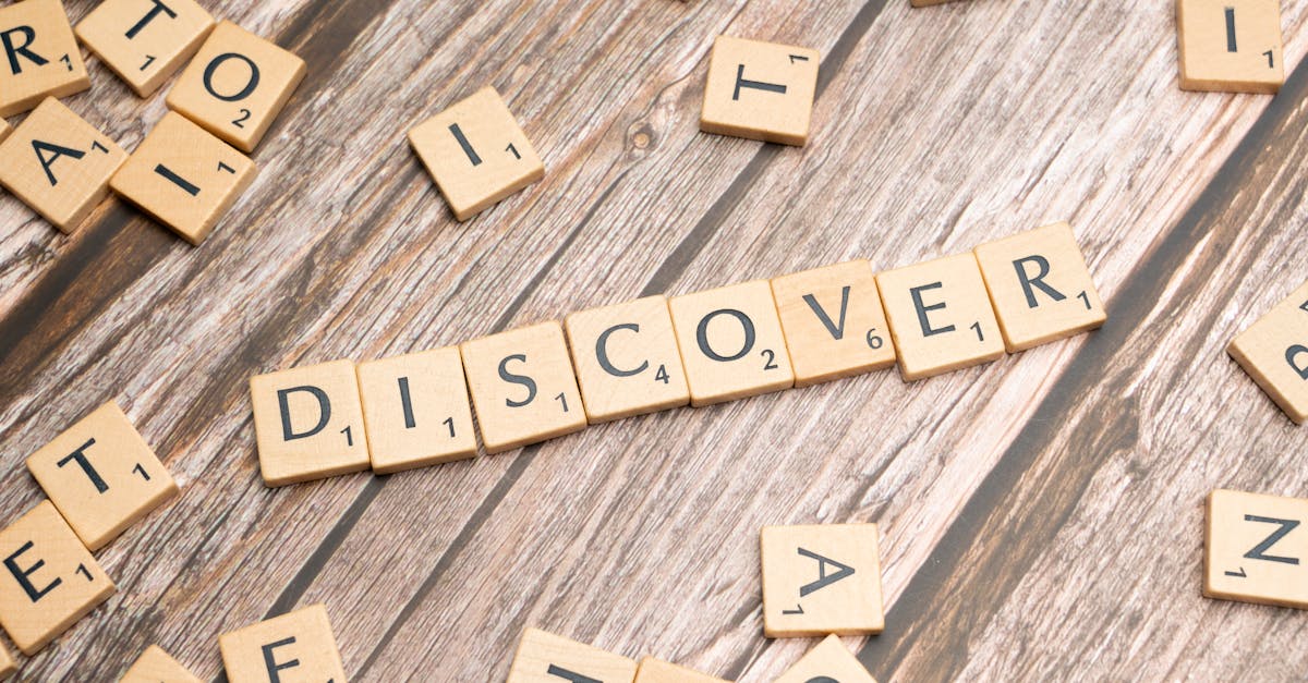 Wooden tiles spelling 'DISCOVER' arranged neatly on a rustic surface.