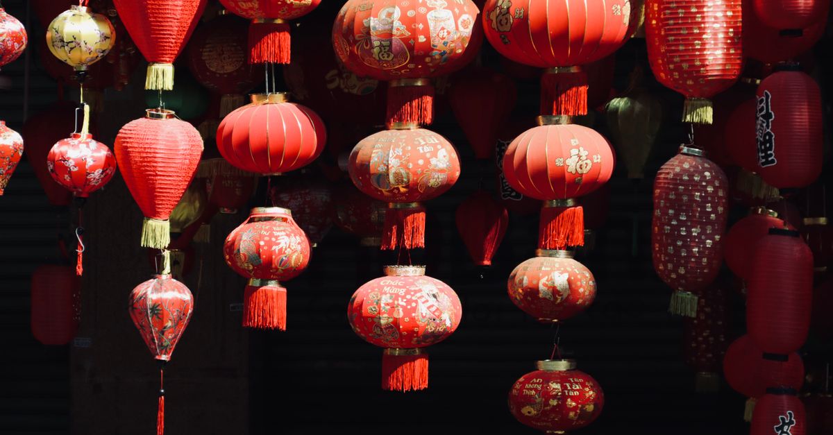 A beautiful array of ornate red Chinese lanterns hanging in the sunlight.