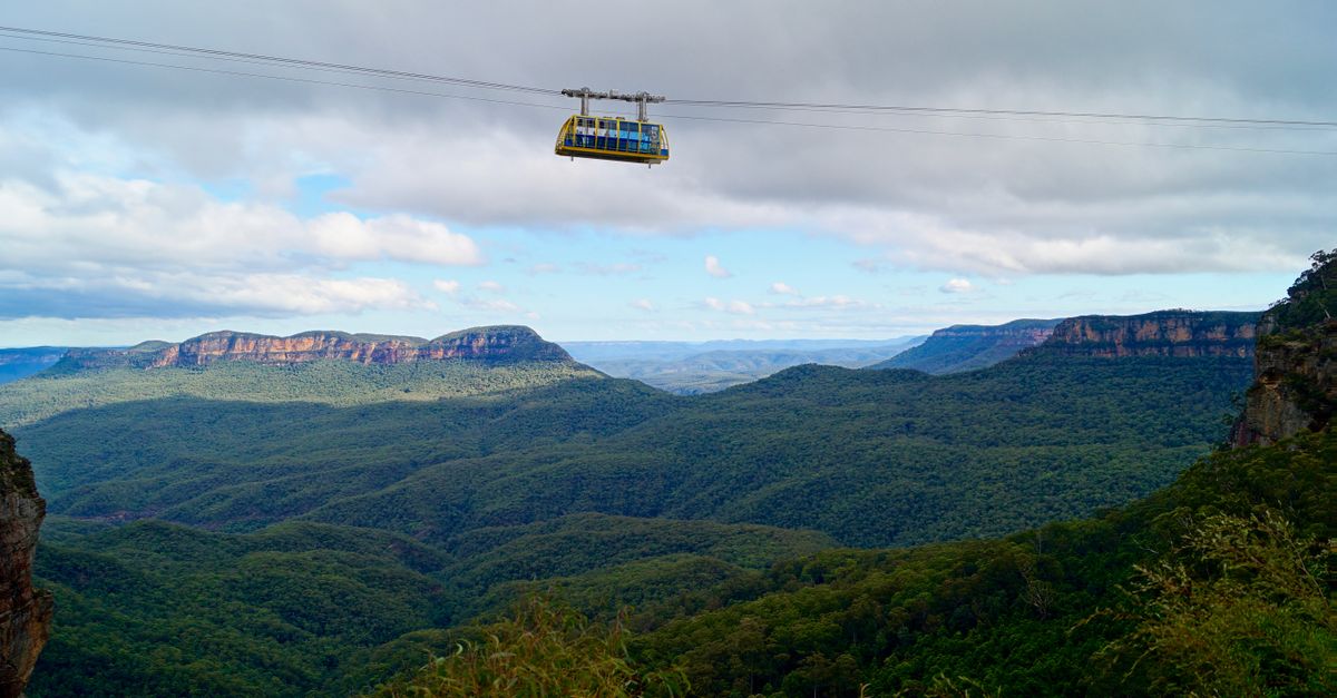 Scenic view of cable car above lush valleys in Blue Mountains, Australia.