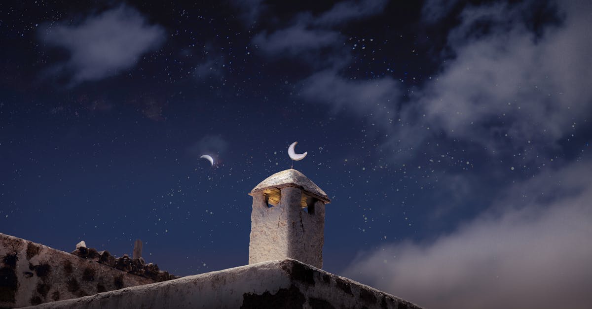 Lanzarote's traditional chimney silhouetted against a starry night sky, highlighting its rustic charm.