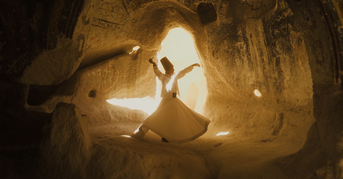 A whirling dervish dances in the mystical caves of Cappadocia, Türkiye.