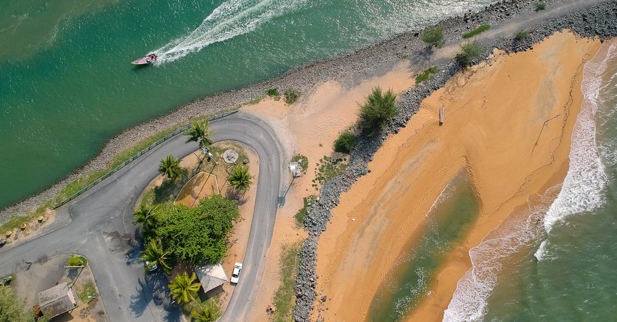 A stunning aerial view of a tropical beach, road, and boat in sunny weather. Ideal for travel and nature themes.