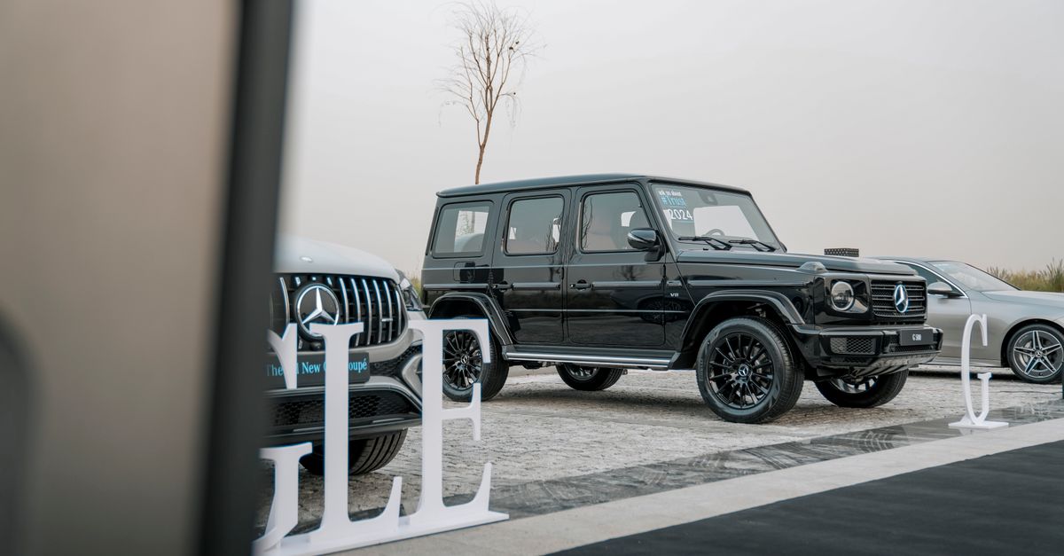 Showcasing luxury SUVs parked outdoors, including a prominent black SUV, highlighting elegance and automotive design.