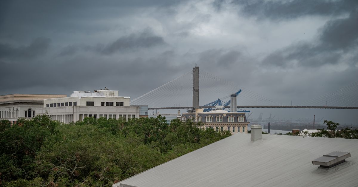 A stormy view of the Talmadge Bridge in Savannah, Georgia, showcasing dramatic clouds and architectural contrast.