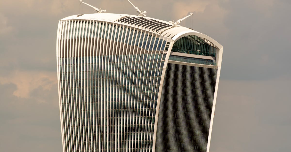 Iconic Walkie Talkie Building in London with cloudy backdrop. Modern architecture marvel.