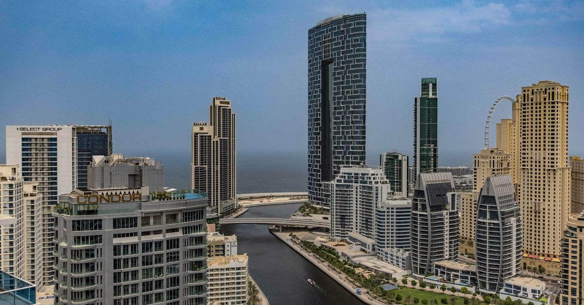 A breathtaking aerial view of Dubai Marina skyline with towering skyscrapers and beautiful canal.