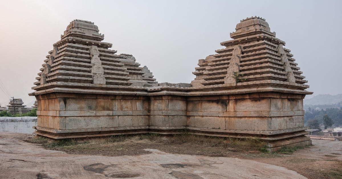 A majestic stone temple in Hampi, Karnataka, showcasing ancient architectural beauty at sunrise.