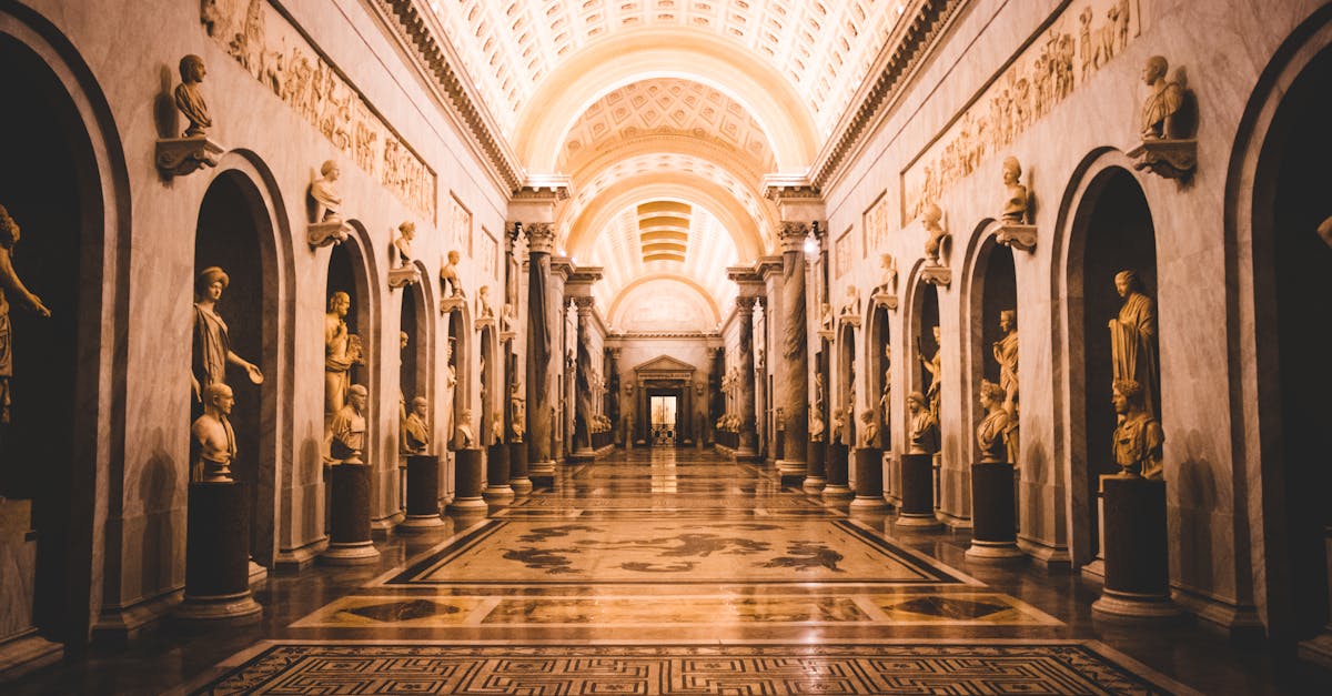 A stunning view of a hallway adorned with classical sculptures in the Vatican Museums.