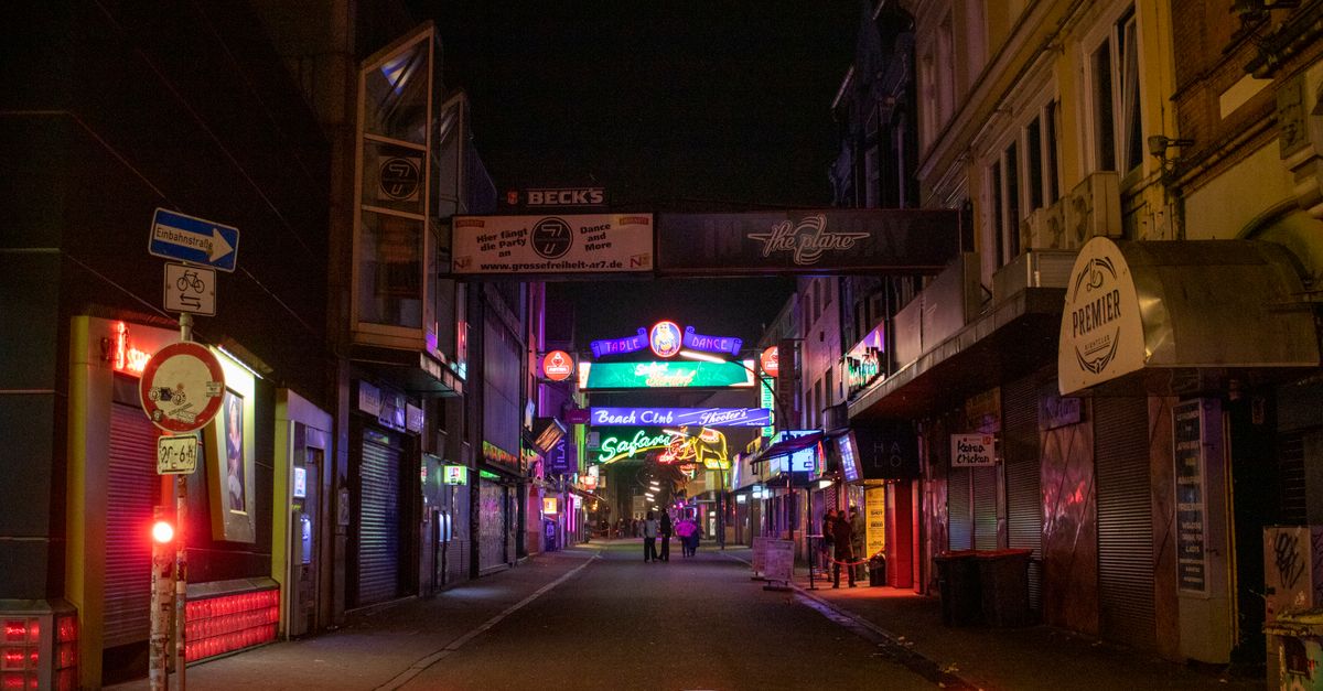 Explore the colorful nightlife of Grosse Freiheit in Hamburg's famous Reeperbahn district at night.