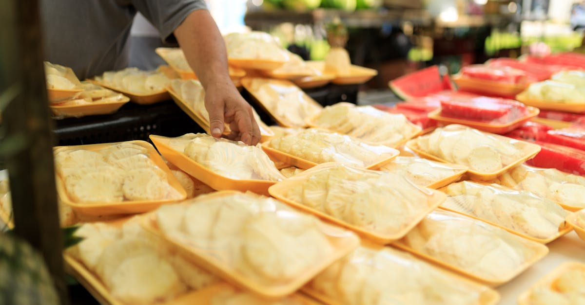 A person picking fresh packaged food at an outdoor market.