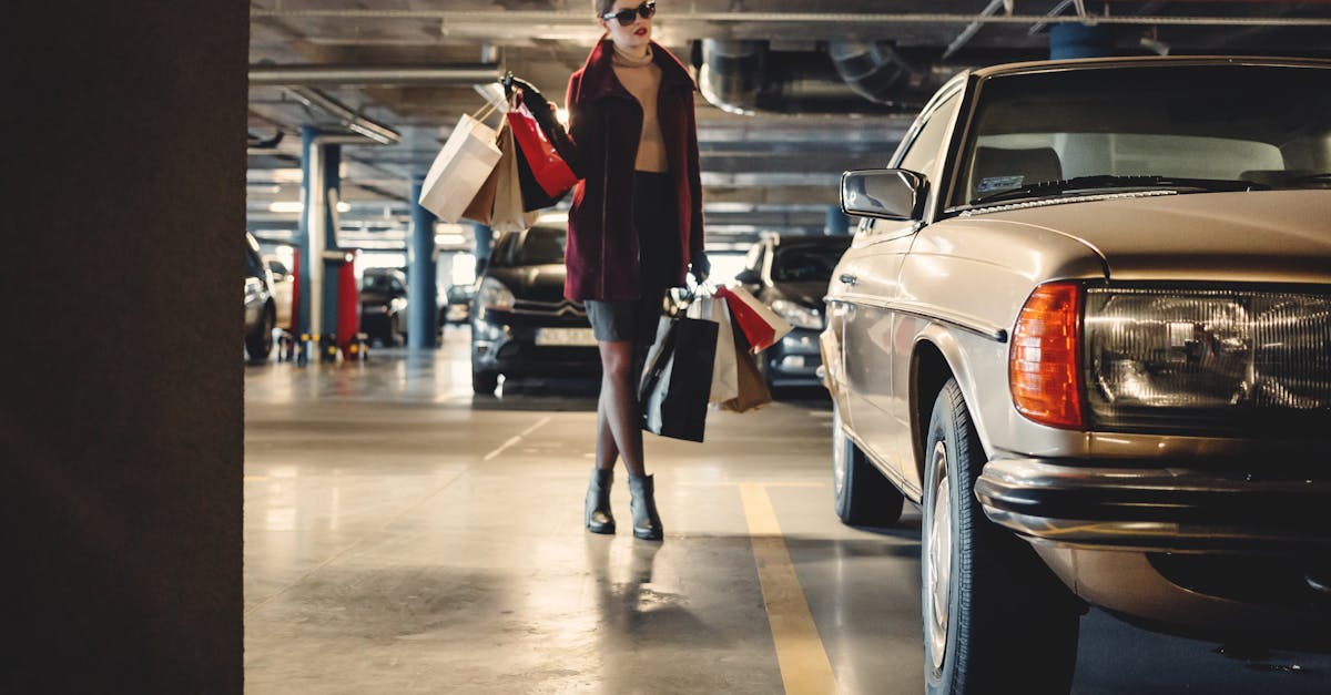Elegant woman carrying shopping bags in an underground parking garage.