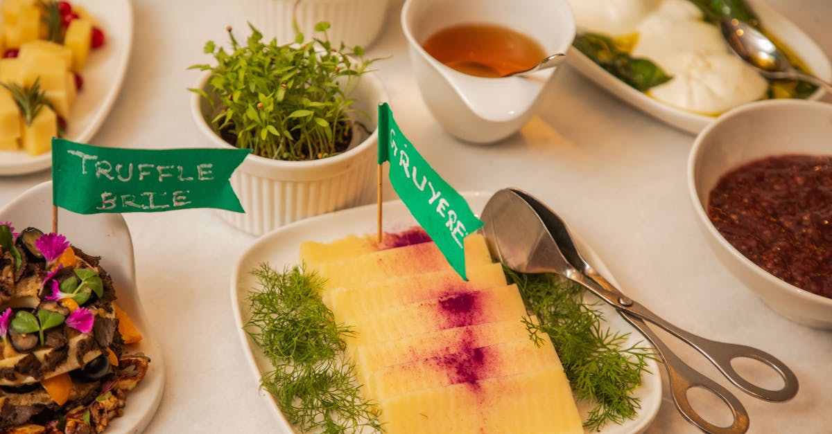 A stylish spread featuring truffle brie and gruyere cheese on a gourmet platter with fresh herbs.