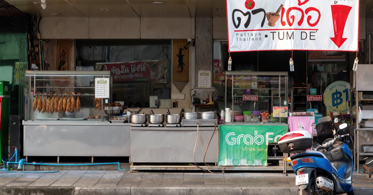 Outdoor street food vendor featuring hanging roast ducks in Pattaya, Thailand.