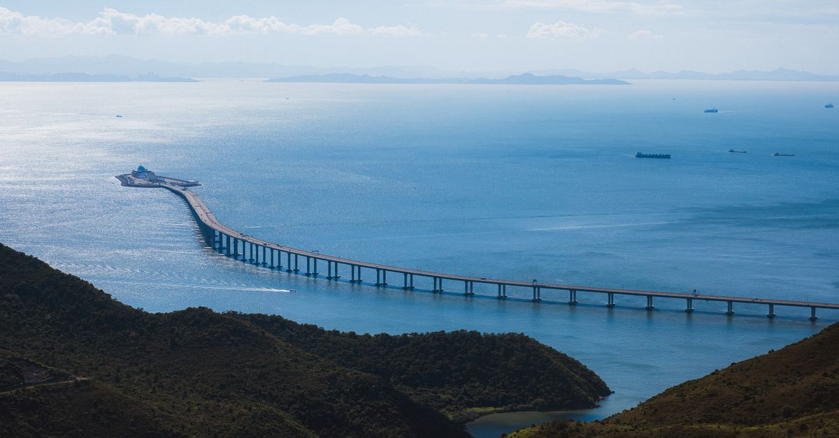 Scenic aerial view of the Hong Kong-Zhuhai-Macau Bridge spanning over tranquil waters.
