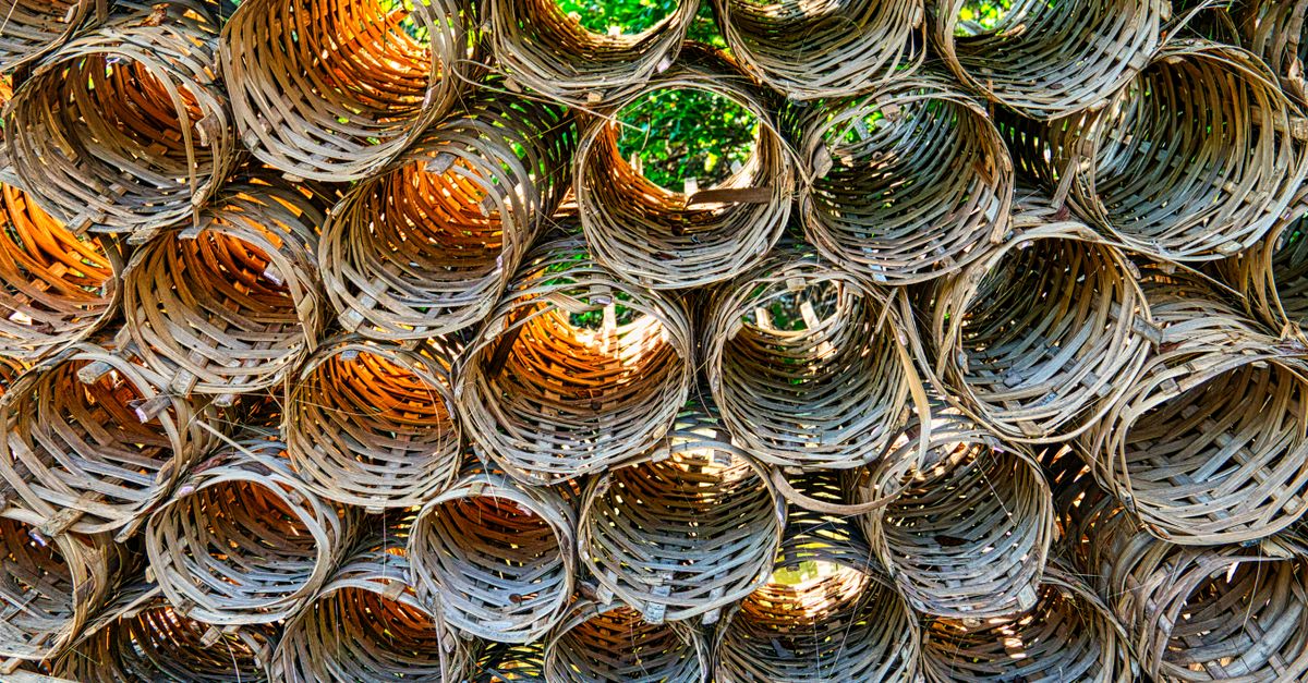 Close-up of stacked wicker baskets showcasing textures and patterns outdoors.