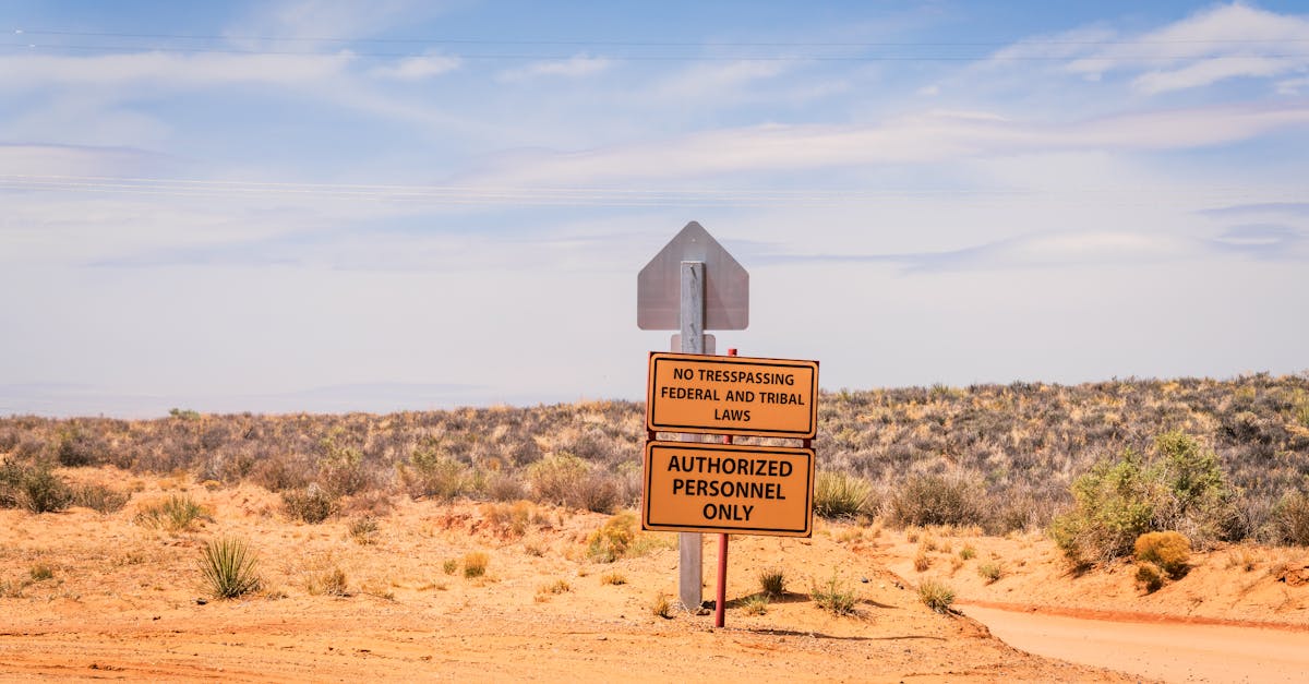 A striking desert scene in Arizona features a no trespassing sign under the expansive blue sky.