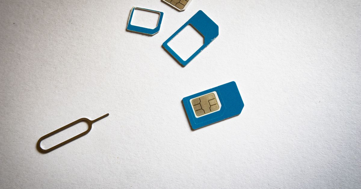 Close-up of SIM cards and ejector tool on white background, emphasizing telecommunication technology.