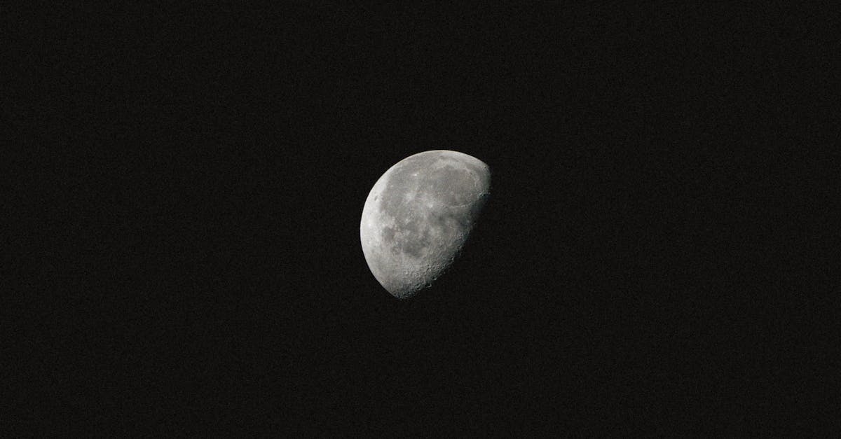 Crescent moon photographed with clear detail against the dark night sky. Ideal for astronomy enthusiasts.