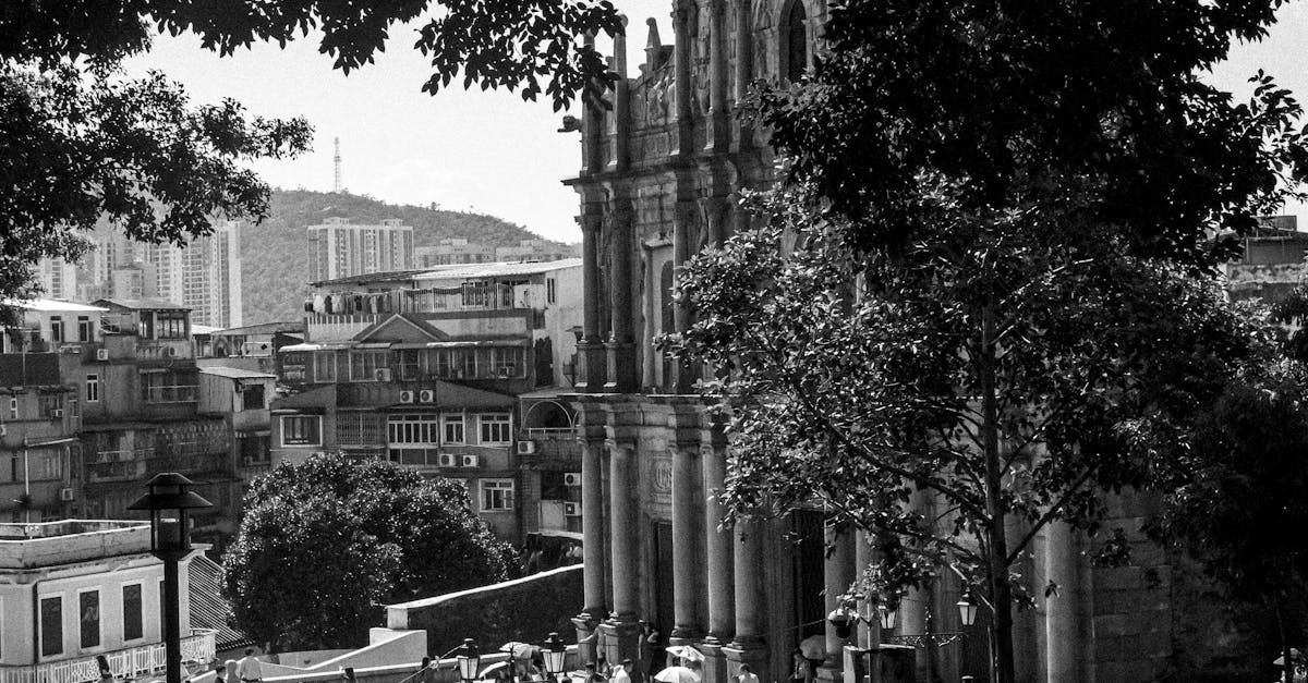 Black and white photograph of the iconic Ruins of St. Paul's in Macau, bustling with tourists.