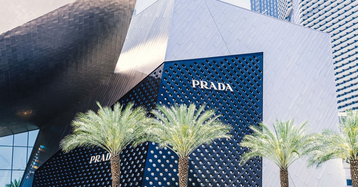 Contemporary architecture of the Prada storefront on Las Vegas Strip with palm trees and unique design.