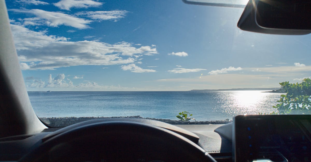 Peaceful sea view from inside a car parked by the coast in Pingtung, Taiwan, under a bright, clear sky.
