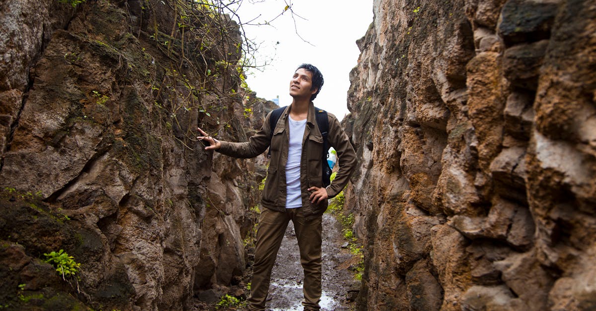Man exploring rocky pathway in Pachacamac, Peru. Adventure and history intertwine in this outdoor journey.