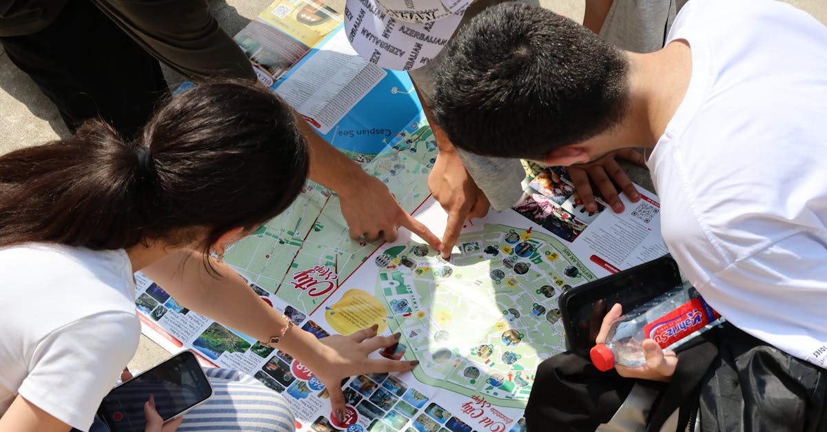 A group of young adults examining a city map outdoors, pointing excitedly at locations.