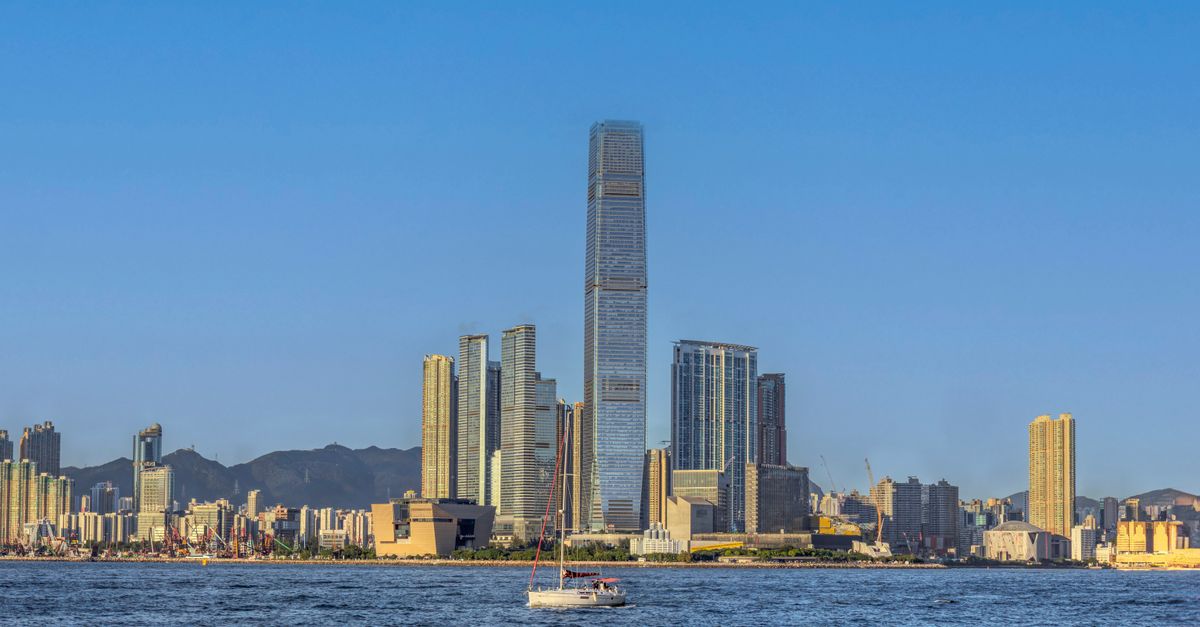 Stunning view of Hong Kong skyline featuring the iconic ICC Tower against a clear blue sky.