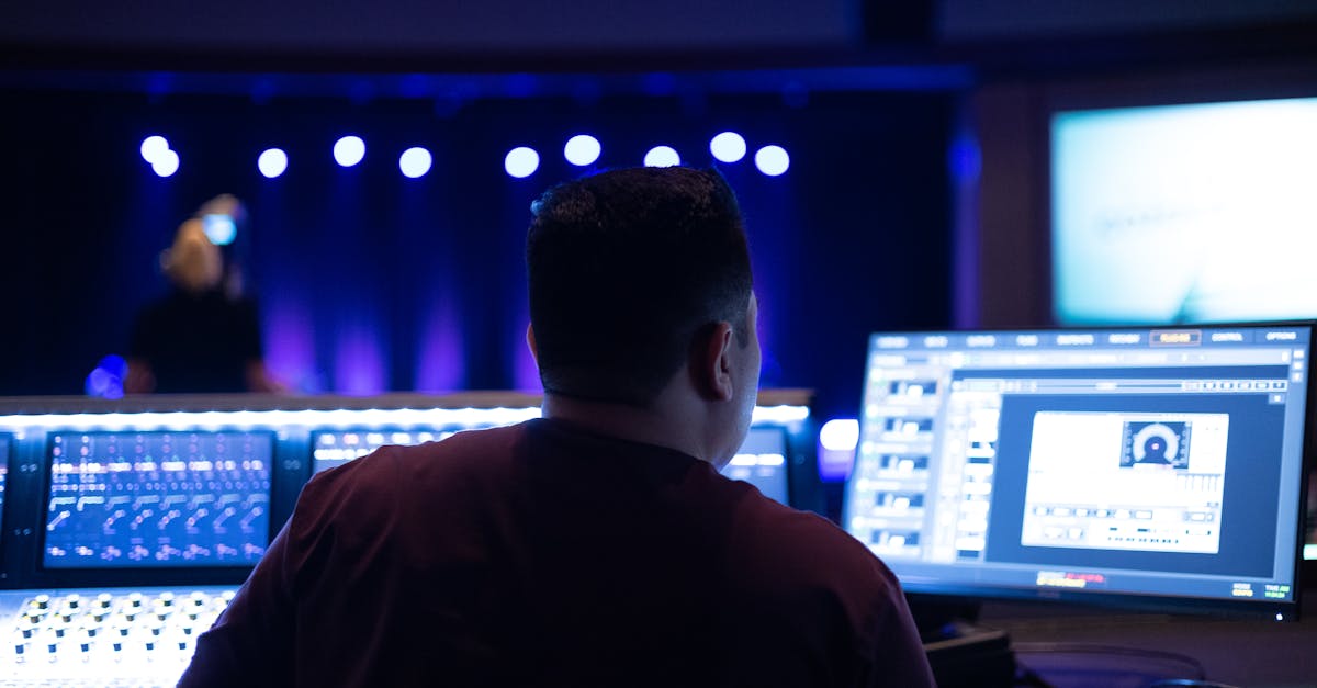 Audio engineer working with sound equipment and mixing console in a studio.