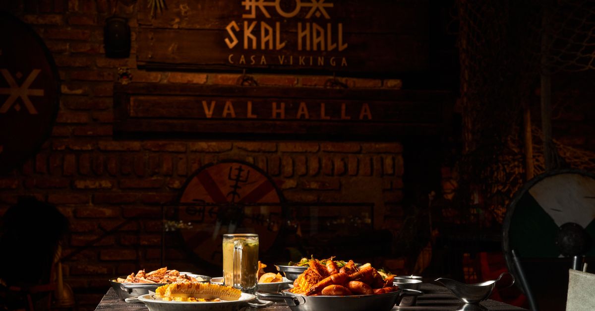 Viking-themed meal setup in a rustic hall with traditional decor and assorted dishes.